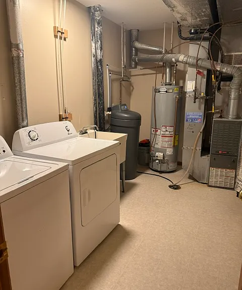 LAUNDRY WITH WASHER, DRYER AND SINK.