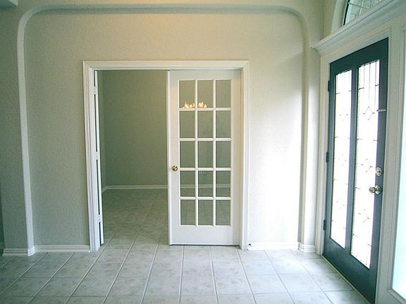 Tile continues throughout the study with attractive glass paned French door entry.