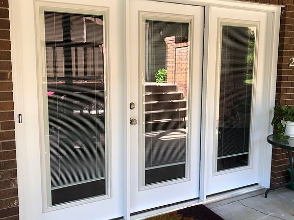 Front entrance, garden level, full light windows with blinds.