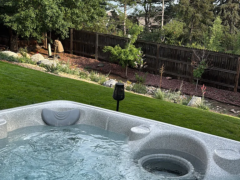 5 person hot tub in fenced backyard