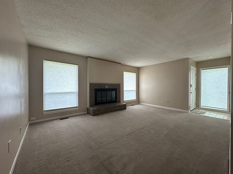 Living room with gas fireplace unman level with two bedrooms, two bathrooms, dining room and kitchen