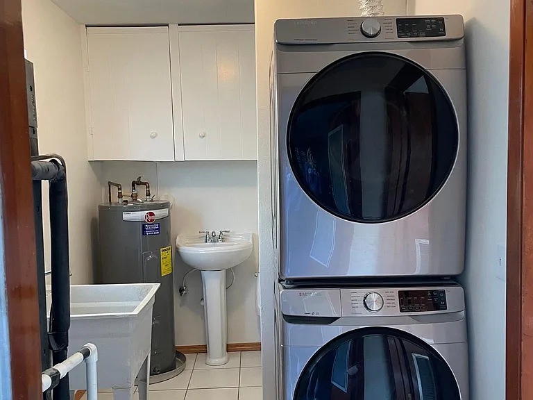 Near the kitchen is this freshly painted laundry room with half bath. Brand new washer & dryer just installed.