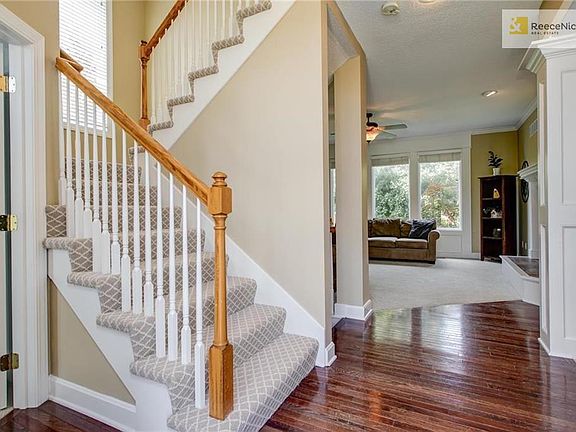 Open the door to an open first floor with new patterned stair carpet