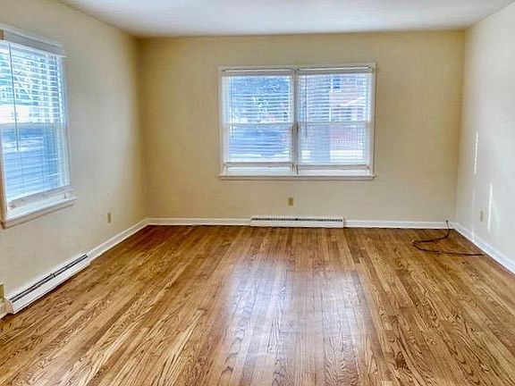 Living Room with hardwood floor, blinds on windows.