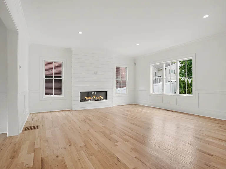 Sun_Washed Hardwood Floors in a Light, Modern Finish Create a Soft Coastal Backdrop for the Home's Open, Inviting Layout.