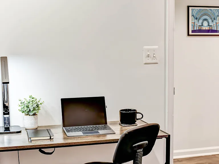 This room offers ample space to comfortably incorporate a desk or dedicated workspace, perfect for working or studying from home.