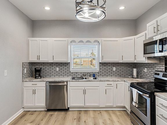 Fully furnished kitchen with cook ware, refrigerator, stove, dishwasher, stove, and microwave.