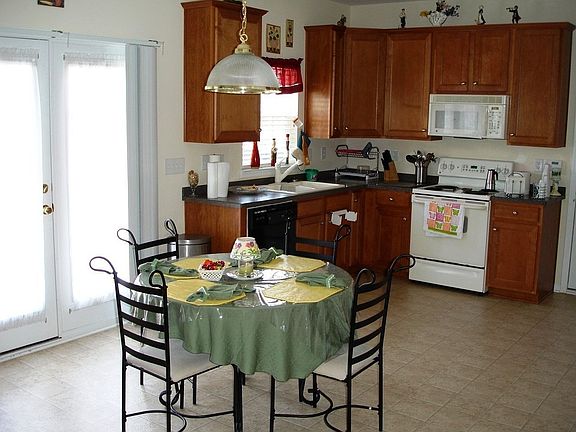 Open Kitchen & Breakfast Area with 42" Wood Cabinets.