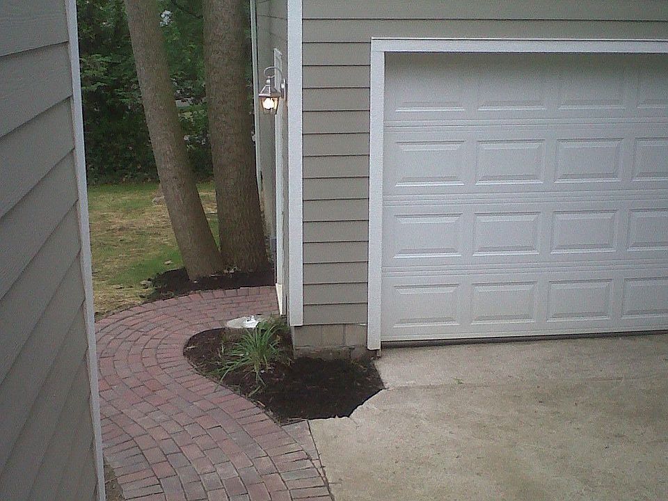 Paver pathway leading to new construction, oversized 2-car garage.