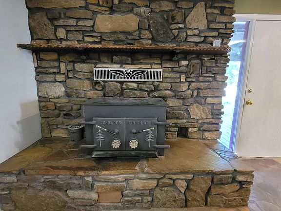 Close up of wood stove and rock work in the family room