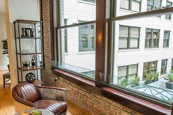 Brick walls and oversized windows were original elements from the building that was renovated and updated to maintain the historic nature of the building and at the same time gives the space timeless style.