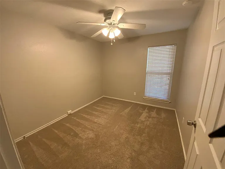 Room featuring plush carpet, a window with horizontal blinds, and a ceiling fan with integrated lighting