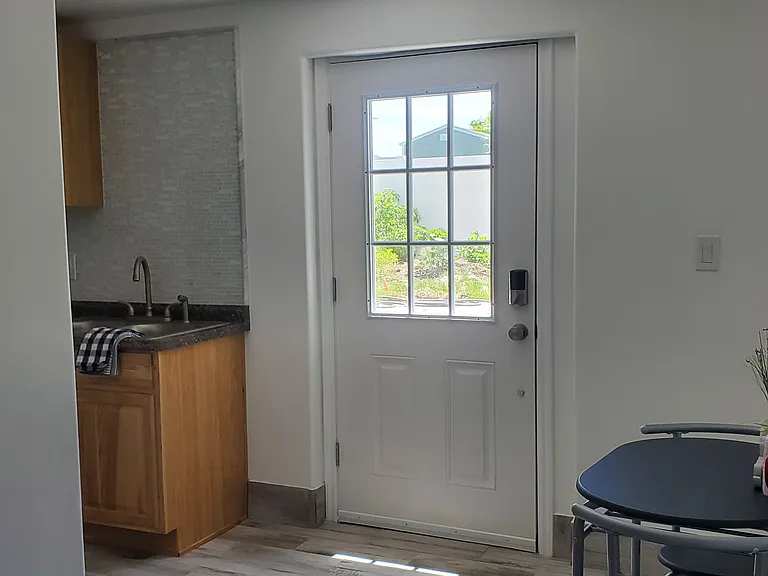 Beautifully lit entryway with plenty of natural sunlight. Even as a basement unit, the large door window brings in a bright and airy feel to your home.