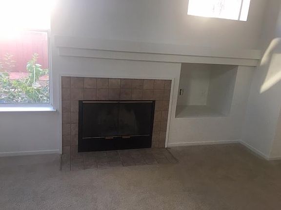 Living room fire place tons of natural light