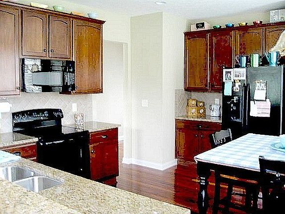 Kitchen has cherry 42" cabnts and granite counters and Tigerwood cherry floors