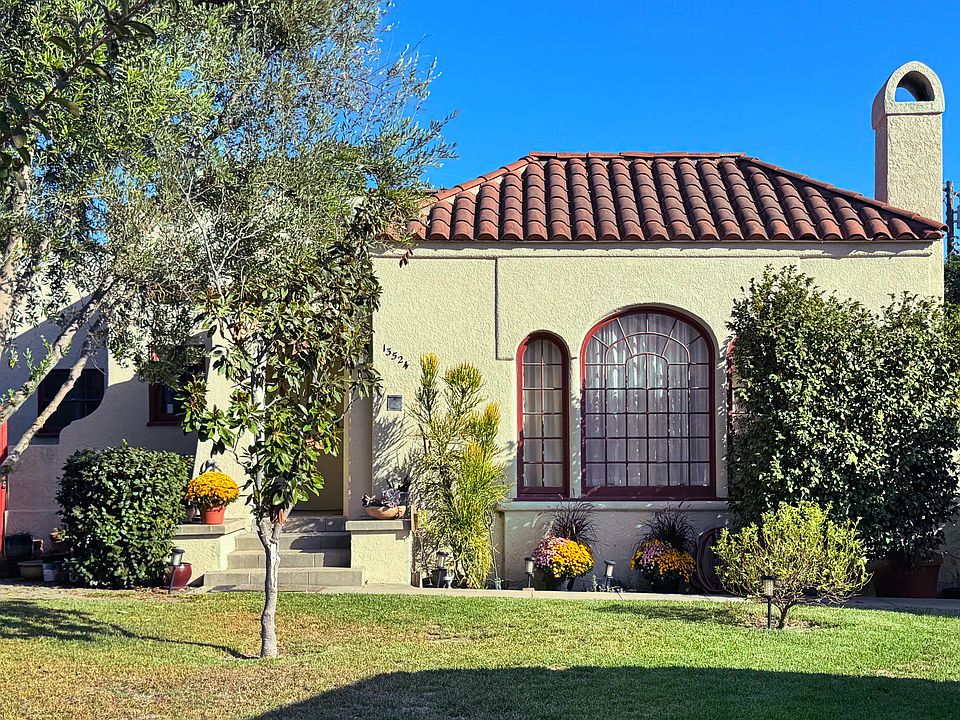 Front of house with beautiful olive tree, and Magnolia tree