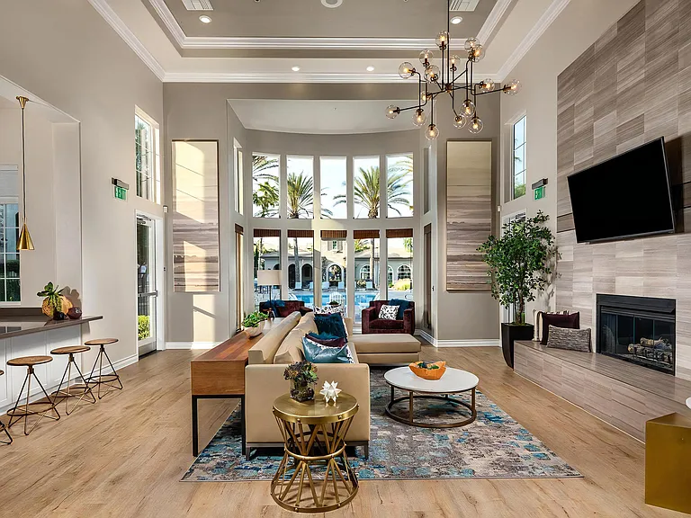 Open-Concept Community Living Area with Tall Windows and Lounge Furniture