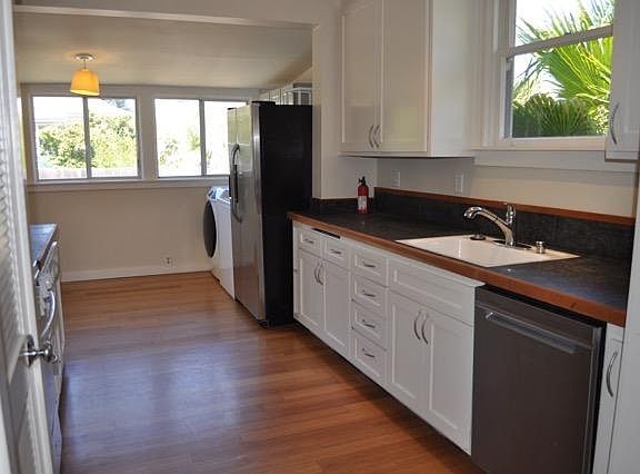 Large, sunny kitchen with farmhouse sink.