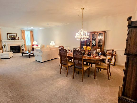 View from the hallway showcasing the exceptional depth, architectural trim, and effortless transition between spaces.