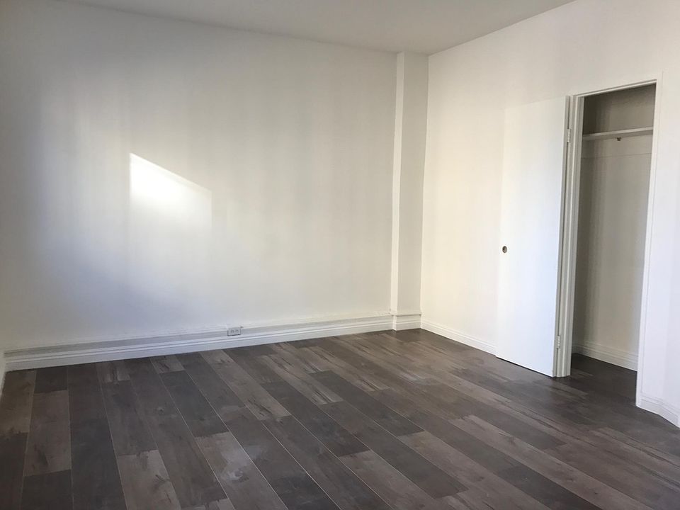 Bed room with wood floor.