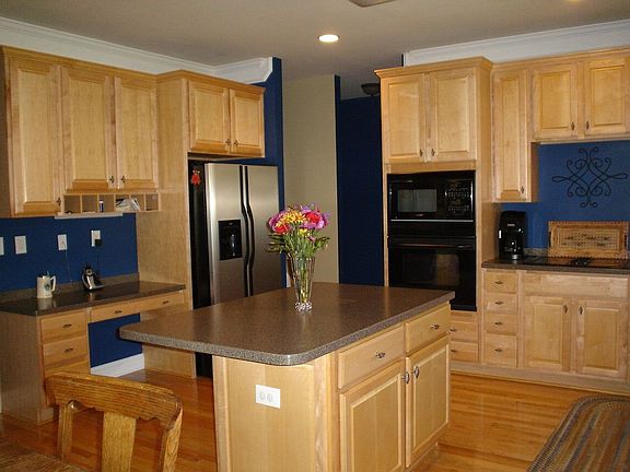 Kitchen that makes cooking a pleasure features Maple Cabinets & an Island