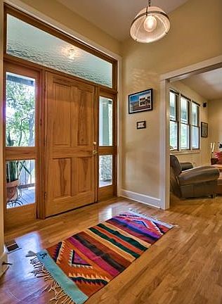 Front foyer with opening to living room on right side of photo