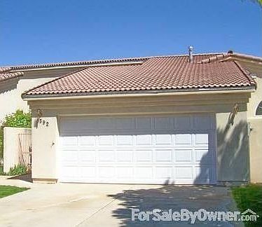 Stucco Exterior front - 2 car garage, Spanish style concrete roof tile.