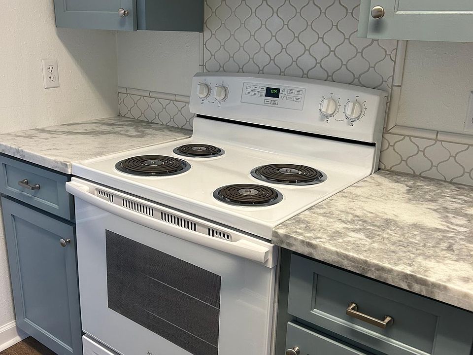 Kitchen-new granite, cabinets, stove, backsplash.