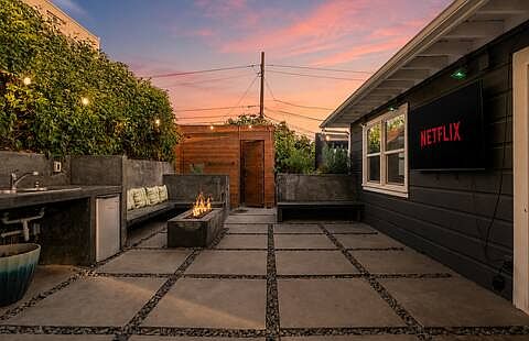 Spacious backyard packed with fun! Comfortable lounges, gather around the fire pit, cook on the pizza oven or BBQ, play the giant chess set, enjoy the playground, or watch movies on the large projector screen. Endless ways to play and unwind.