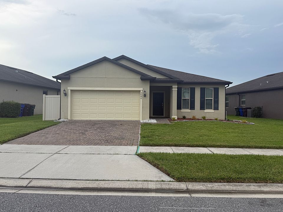 Front of the home with 2 car Garage and Paver driveway