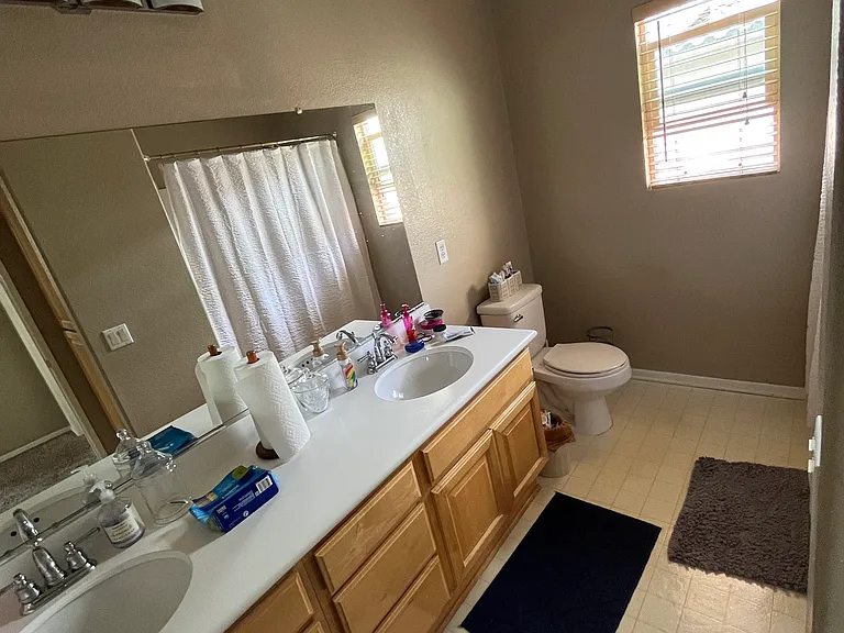 Dual sink second full bathroom upstairs with shower tub combo