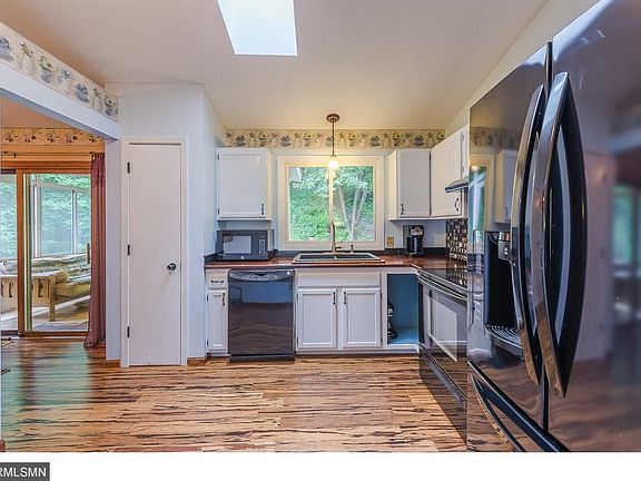 Kitchen has been recently updated with white painted cabinets, black appliances, bamboo flooring! Wood and granite countertops and deep sink!