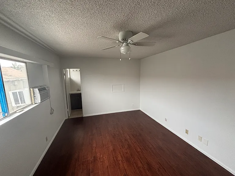 Bedroom #1 w/ AC unit and ceiling fan