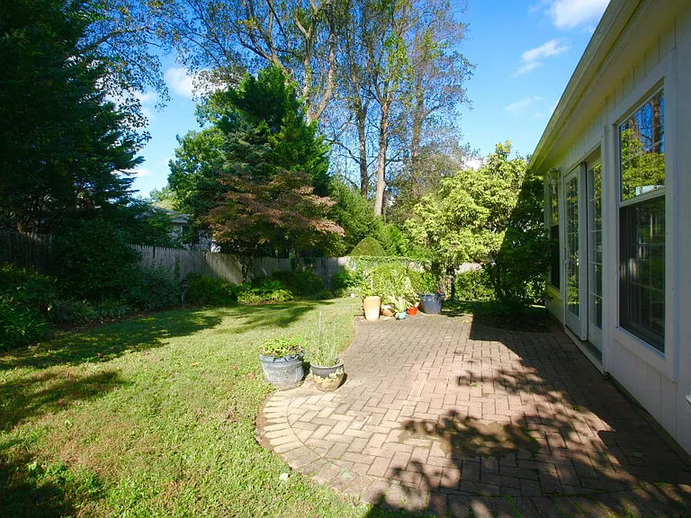 Beautiful, professionally landscaped large, fenced in backyard with brick patio.