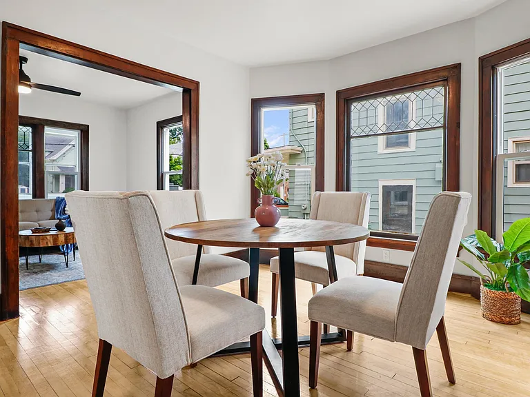 Shot of the dining room leading into the living area. Note the unique vintage windows.