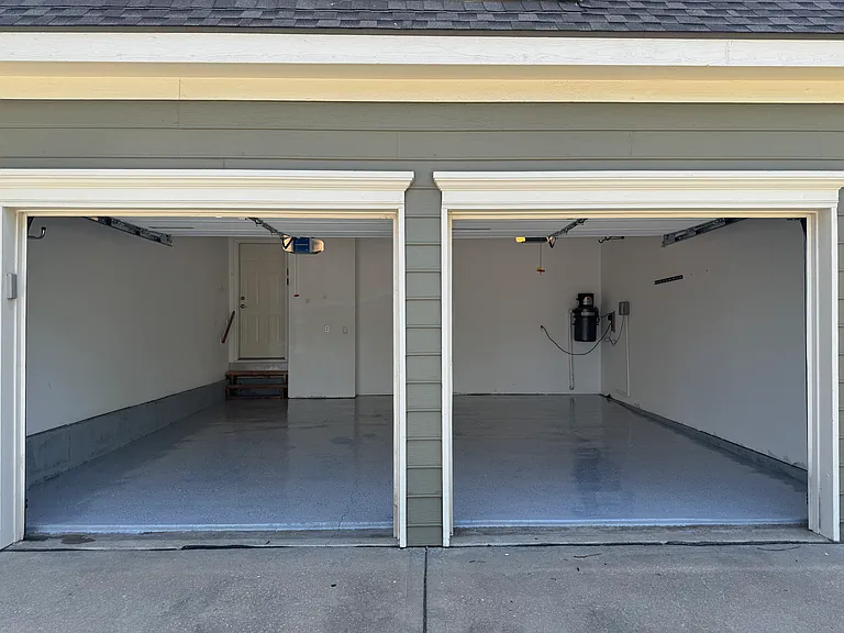 Finished garage with clean epoxy-coated flooring. NEMA 14-50 for any EV needs.