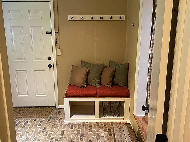 (2 of 3) Rear entry mud room that leads to a half bath/laundry and the kitchen area.