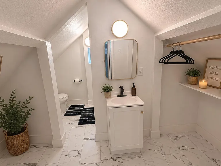 Well-appointed bathroom with a vanity sink, mirror, and open closet shelving for linens, plus tile-style flooring.