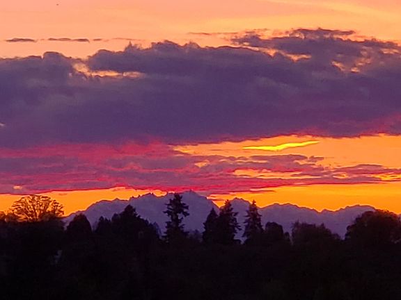 Unfiltered cell phone shot of a Seattle sunset from the off-street parking pad of this special property. There is room for 2 cars.