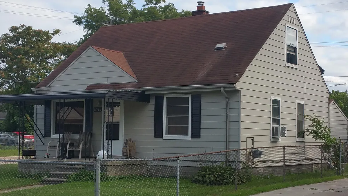 Roof replaced and now dark grey. - 8746 Hudson Ave