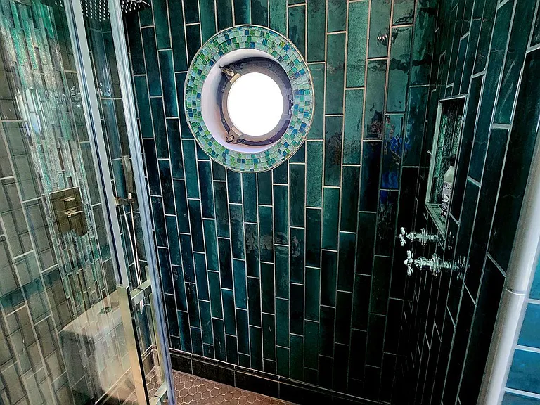 Double head shower with porthole window.