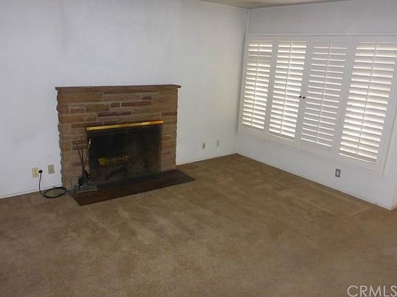 Large Living Room with Wood Plantation Shutters, Wood Burning Fireplace with Gas Starter.