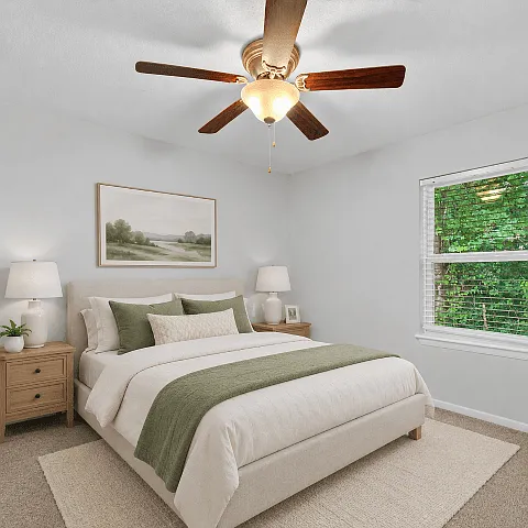 Bright bedroom with plush carpeting and room for a complete furniture set.