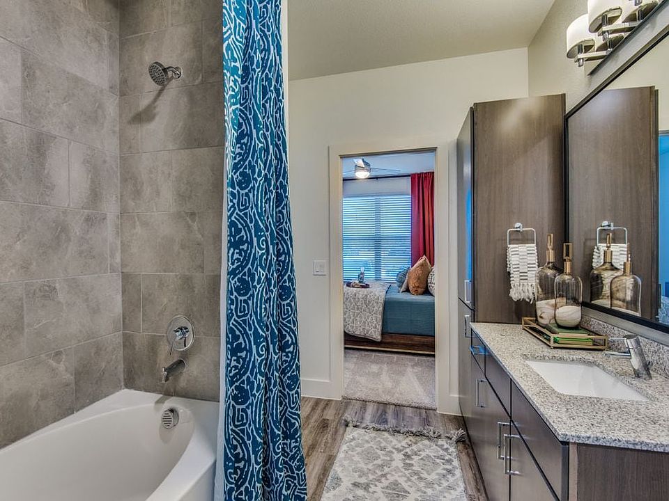 Bath with espresso cabinetry, speckled granite countertops, and hard surface flooring