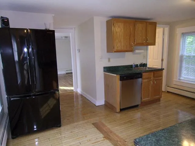 Kitchen looking the dining room through hall to left of dishwasher.