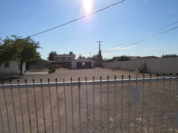 Street looking towards garage, house to left