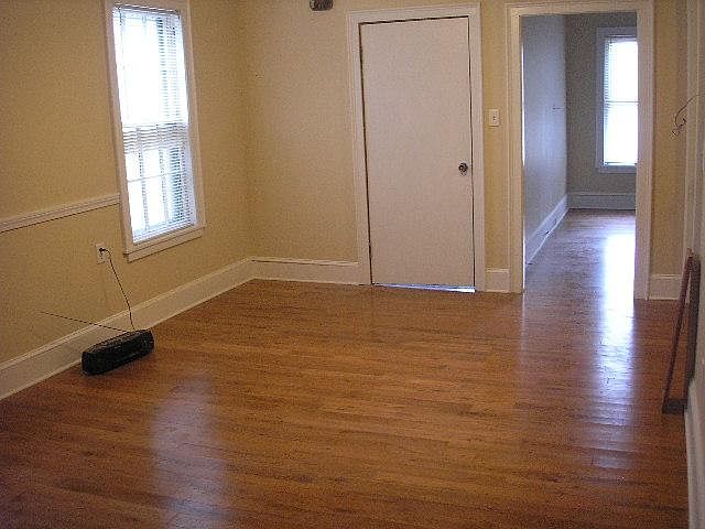 living room, facing front door and looking into front bedroom