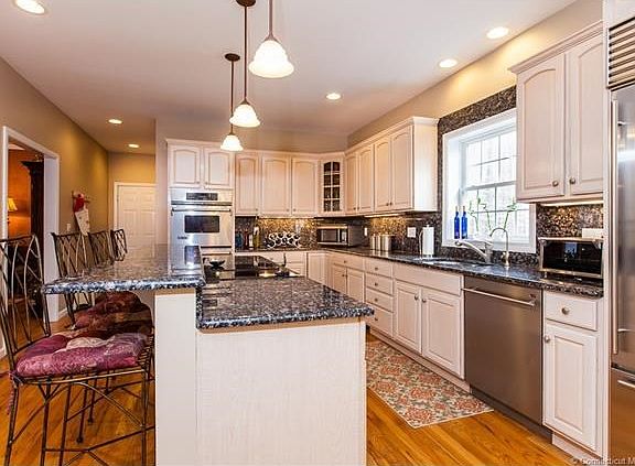 Wood floors, double ovens, stainless steal sink and appliances, lots of cabinets, granite counter tops,Subzero, JennAir, drop down and canned lighting,window overlooks back deck. This kitchen has all the modern expectations!