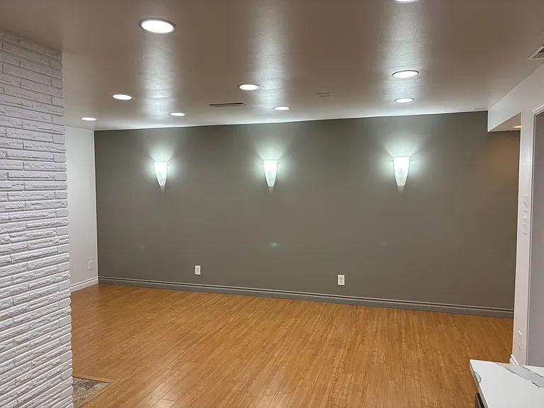 Feature wall with dimmable wall scones.