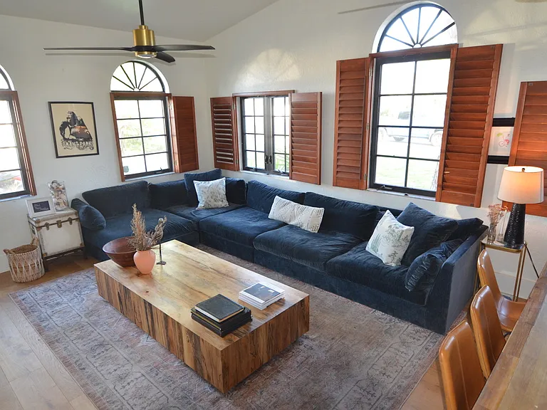 Huge Crate and Barrel sectional couch with 86" smart TV.